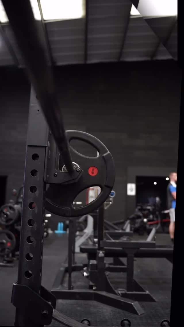 Rack with a loaded plate on the gym floor